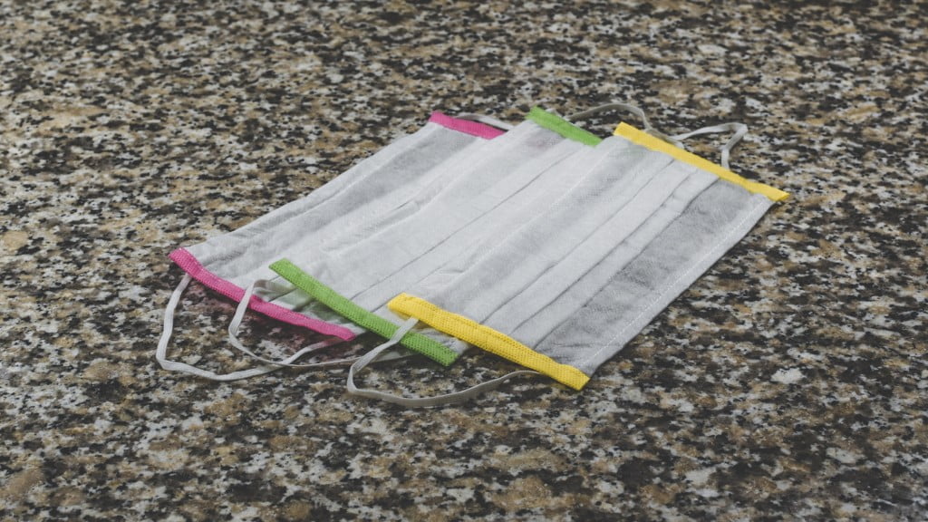 The Essentials (part IV): Three colorful surgical masks on a marble surface.