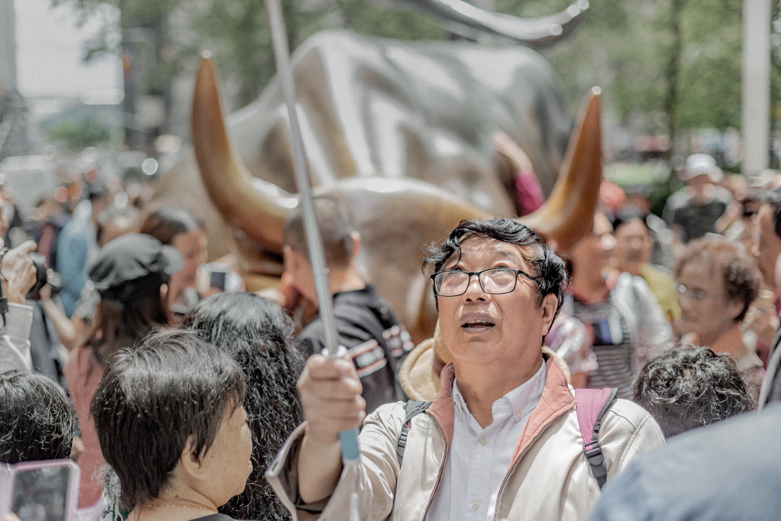 Asian tourists at Wall Street Bull in New York