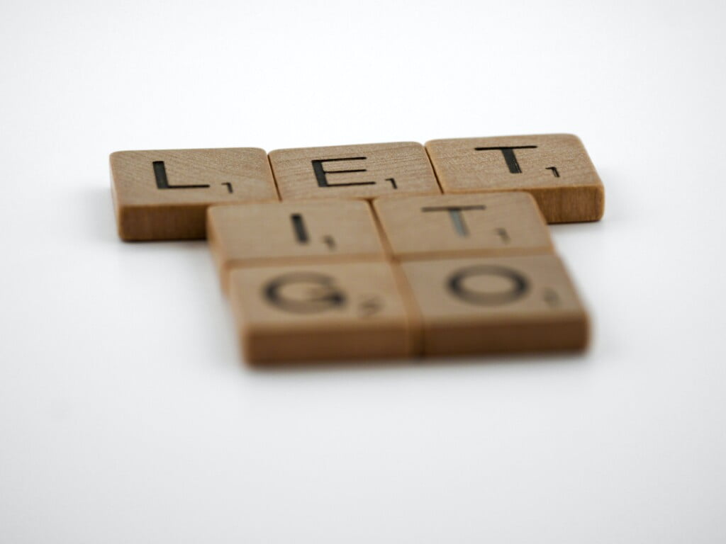 scrabble, scrabble pieces, lettering, letters, wood, scrabble tiles, white background, words, type, typography, design, layout, let it go, forgive, forgiveness, obsession, frozen, disney, move on, regret, despair,