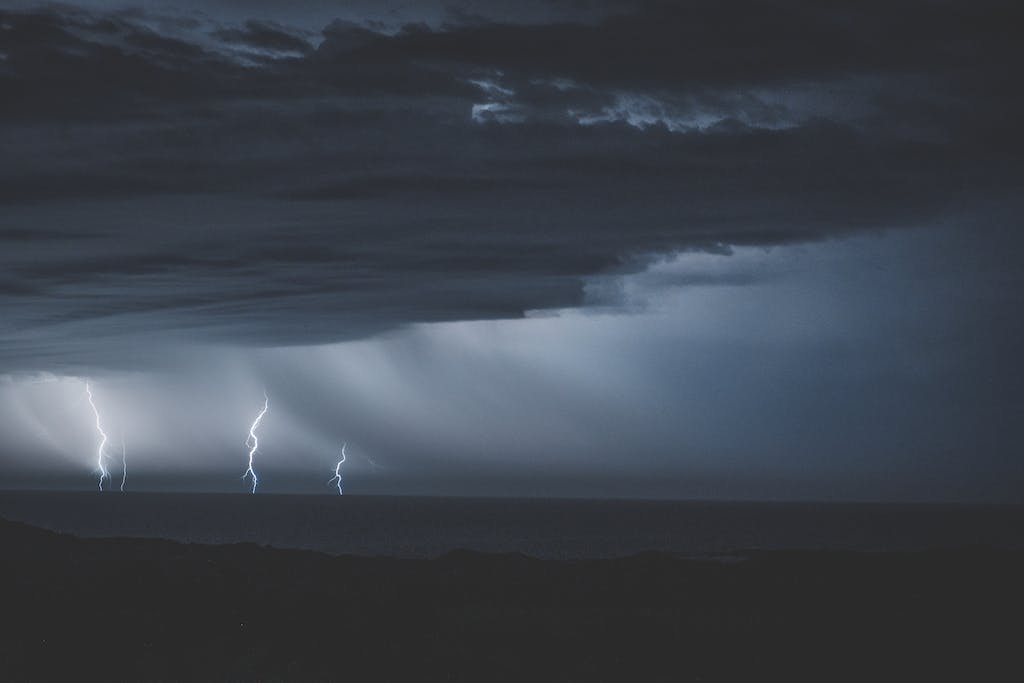 Thunderstorm with glimmering lightnings over ocean